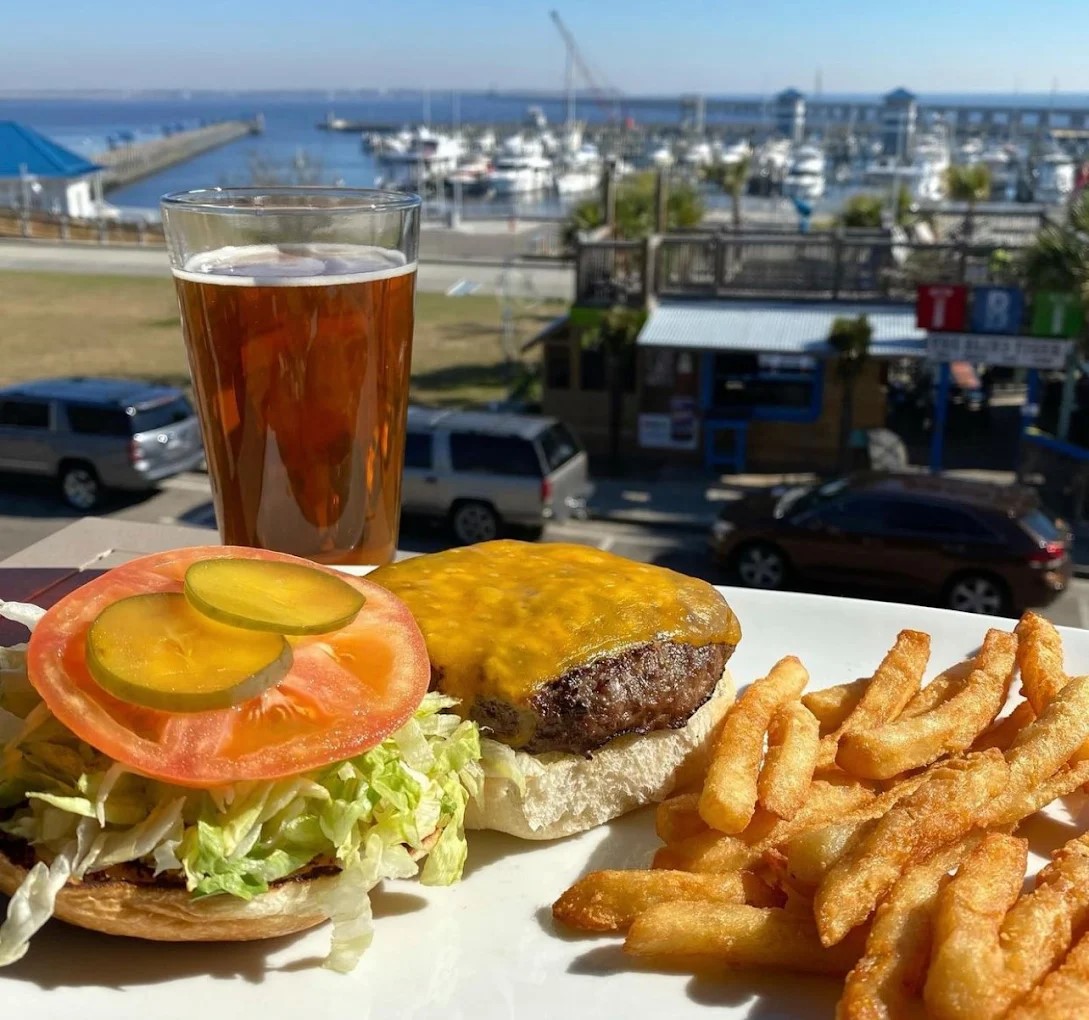 200 North Beach burger and seasoned fries with cold beer - balcony view over the Bay of St. Louis harbor.