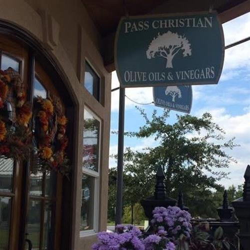 Pass Christian Olive Oils and Vinegars logo on storefront sign