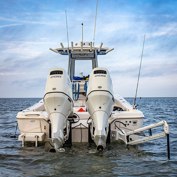 Fishing Boat with dual engines and fishing pole rod holders floating the Bay of St. Louis.